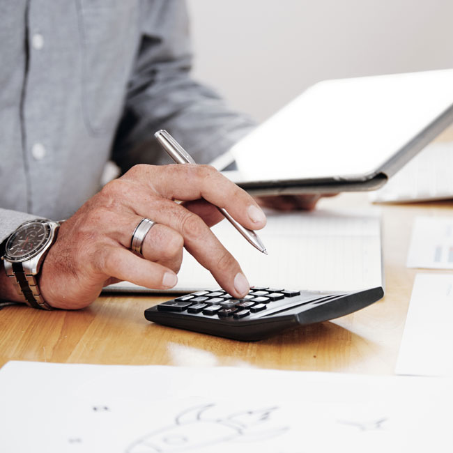 outsourced accounting professional from Optima using a calculator